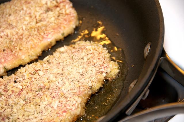 fry pork loin crusted with panko breadcrumbs in a frying pan