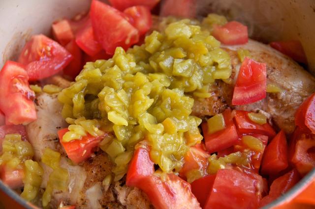 tomatoes green chiles and mexican seasonings with chicken in iron cast dutch oven