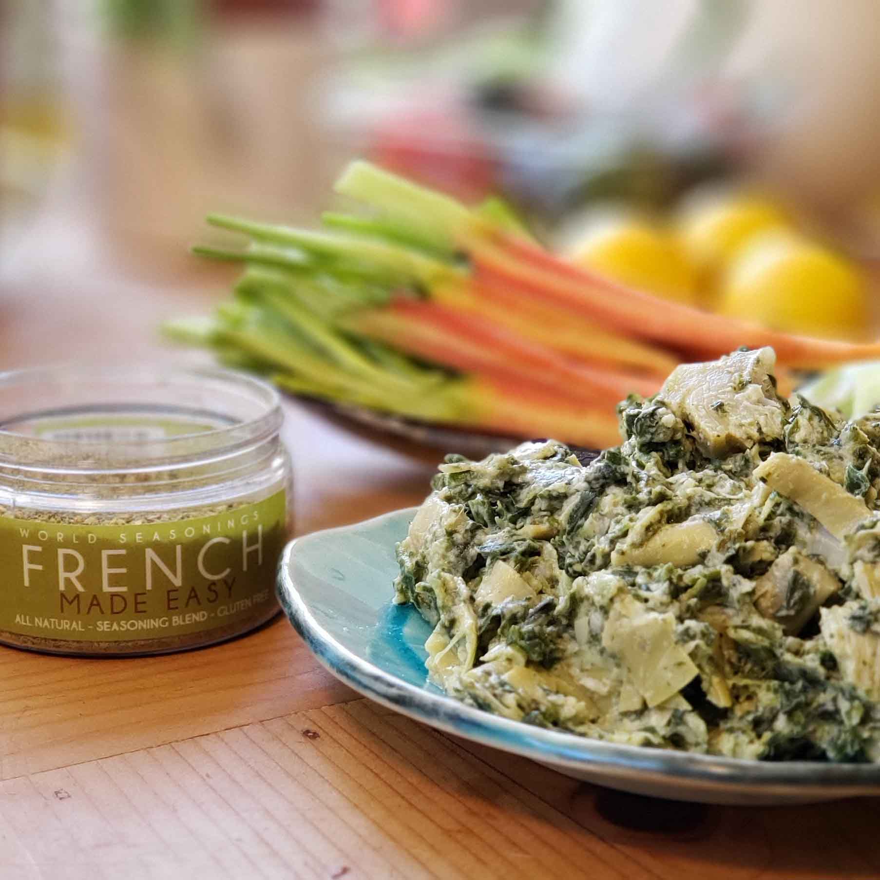 Picture of the spinach dip finished on a blue plate and a container of french made easy next to it.