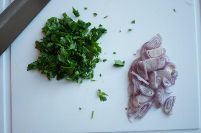 chopped parsley and shallots on cutting board