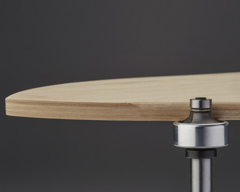 Trims a perfectly rounded edge on a 3-dimensionally shaped skateboard.
