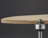 Trims a perfectly rounded edge on a 3-dimensionally shaped skateboard or bent hardwood project.