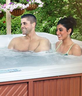 Majestic Series Spas couple relax in hot tub.