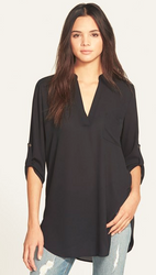 Women wearing a black long sleeve tunic shirt. 