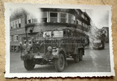 aa568 - Wehrmacht Heer trucks on parade through German town with flags