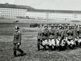 aa695 - Wehrmacht Heer unit march past with large barracks buildings in background