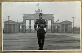 aa808 - Grenztruppen Berlin soldier in front of Brandenburg Gate with Kalashnikov - given as an award
