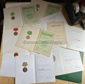 ab759 - large lot of award certs with folder to a Wachtmeister of the Volkspolizei VP VoPo police