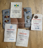 ac308 - nice lot of award badges and certificates for an East German youth