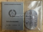 ac673 - NVA WDA Wehrdienstausweis document with dog tag - c1974 Strausberg