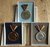 om301 - East German NVA, Grenztruppen and Stasi Reservist Medals with Steel Helmet - complete set in boxes