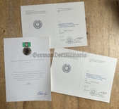 od009 - 2x medal of national defence work + Herder medal in gold blank award certificates