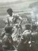 ad355 - HJ boys in uniform with armbands helping a young woman