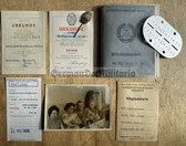 gw279 - NVA WDA Wehrdienstausweis document with dog tag, award certificates and other docs  - dark collar uniform photo - c1974 Wanzleben - Gefreiter - FLAK Artillery