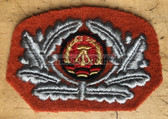 pa027 - original East German paratrooper FJ Fallschirmjäger orange beret badge
