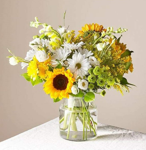 Give a dose of sunshine in bloom. This stunning bouquet is teeming with rays of sunflowers, textured snapdragons and darling daisy poms to deliver the perfect pick–me–up for an occasion or as a treat to yourself.

Please Note: The bouquet pictured reflects our original design for this product. While we always try to follow the color palette, we may replace stems to deliver the freshest bouquet possible, and we may sometimes need to use a different vase.