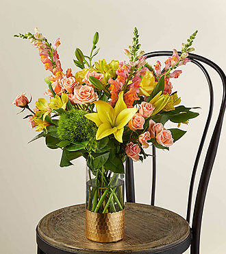 The Sunbeam bouquet is the perfect gift to send positivity their way. Nothing cheers up Mother like sunny yellow lilies and charming peach roses expressing your well wishes. This arrangement looks even more stunning in the tall glass, gold-dipped vase.