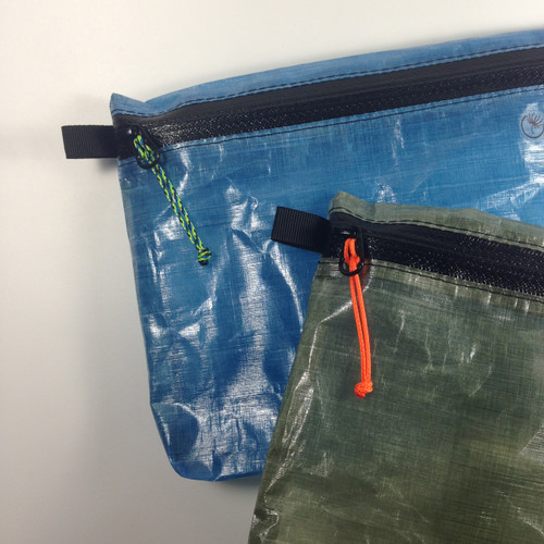 Aquatica on blue pouch, Neon Orange on olive green pouch