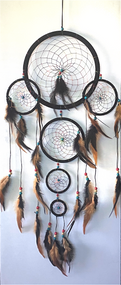 Dream catchers are one of the most fascinating traditions of Native Americans. 

This handmade dream catcher is intended to protect the sleeping individual from negative dreams while letting positive dreams through. The positive dreams will slip through the center of the dream catcher, and glide down the feathers to the sleeping person below. The negative dreams will get caught up in the web, and expire when the first rays of the sun strike them.

Measurements: Top ring is 11" diameter, length is approximately 32".
Dimensions will vary slightly due to the handmade nature of this product.