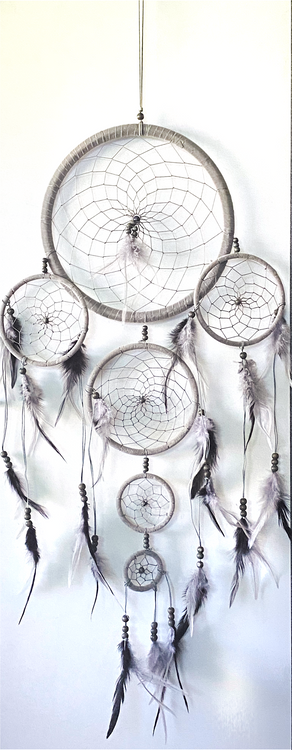 Dream catchers are one of the most fascinating traditions of Native Americans. 

This handmade dream catcher is intended to protect the sleeping individual from negative dreams while letting positive dreams through. The positive dreams will slip through the center of the dream catcher, and glide down the feathers to the sleeping person below. The negative dreams will get caught up in the web, and expire when the first rays of the sun strike them.

Measurements: Top ring is 11" diameter, length is approximately 32".
Dimensions will vary slightly due to the handmade nature of this product.