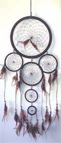Dream catchers are one of the most fascinating traditions of Native Americans. 

This handmade dream catcher is intended to protect the sleeping individual from negative dreams while letting positive dreams through. The positive dreams will slip through the center of the dream catcher, and glide down the feathers to the sleeping person below. The negative dreams will get caught up in the web, and expire when the first rays of the sun strike them.

Measurements: Top ring is 11" diameter, length is approximately 32".

Dimensions will vary slightly due to the handmade nature of this product.