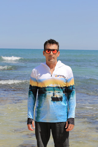 Lightweight quick-dry fishing hoodie being worn in the Australian sun - ARPANSA certified.
