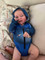 Baby wearing a Hooked Gear Spanish Mackeral fishing hoodie sun suit laying down