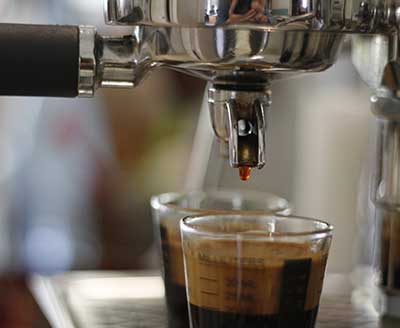Fresh coffee dripping from machine