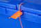 Photograph of single orange closed pull tight seal in use.