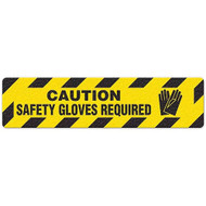 Photograph of an anti-slip floor safety sign reading "Caution Safety Gloves Required" in black on a yellow background.  Includes a graphic of black gloves.