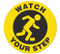 Photograph of yellow and black anti-slip floor marker reading watch your step with graphic.