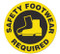 A yellow and black photograph of a 05213 anti-slip safety floor markers, reading safety footwear required with graphic.