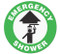 A green and white photograph of a 05223 anti-slip safety floor markers, reading emergency shower with arrow graphic.