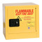 A photograph of a yellow 02014 bench top flammable liquid safety cabinets, with 2 gallon capacity and door closed.