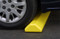 A closeup photograph of a 02260 eagle protective parking stop with car wheel right on it. 