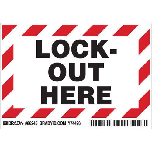 A photograph of a red and white 07019 lock out here peel-and-stick permanent adhesive label.