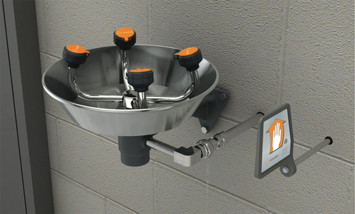 A photograph of a Guardian GFR1724 Freeze-Resistant WideArea™ Eye/Face Wash, Wall Mounted, Stainless Steel Bowl installed on a cinderblock wall.