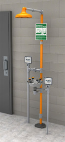 A photograph of a Guardian GFR1909SSH Freeze-Resistant Safety Station with stainless steel bowl mounted next to a cinderblock wall.