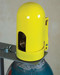 A photograph of front of a yellow 07200 justrite safety snap cap heavy-duty gas cylinder lockout device with padlock in closed position.