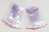 A photograph of several 09390 resealable heavy duty fire extinguisher tag protectors, with 10 per package.