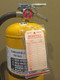 A photograph of a 09390 resealable heavy duty fire extinguisher tag protector in use on a fire extinguisher tag.