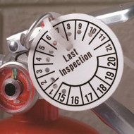 Punched tag shown attached to a fire extinguisher.
