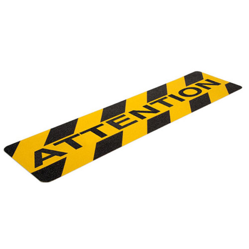 A photograph of a yellow and black 06462 anti-slip stair cleat, reading attention, with 6" x 24" dimensions, and 10 per package.