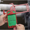 A photograph of a 12256 secure-status safety tag holder installed on a scaffold with safety tag being placed inside.