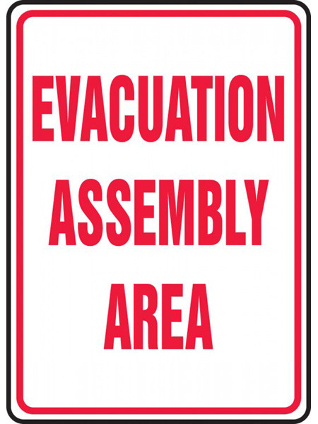 White sign with red border and red lettering of EVACUATION ASSEMBLY AREA.