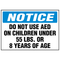 A photograph of a blue and white 13010 AED label reading notice do not use AED on children under 55 lb or 8 years of age.