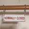 Photograph of a double jack chain set hanging a sprinkler sign on a copper pipe.