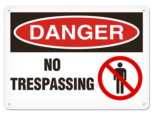 A photograph of a 01639 danger, no trespassing OSHA sign with prohibition icon.