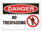 A photograph of a 01639 danger, no trespassing OSHA sign with prohibition icon.