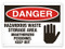 A photograph of a 01632 danger, hazardous waste storage area unauthorized personnel keep out OSHA sign with hand graphic.
